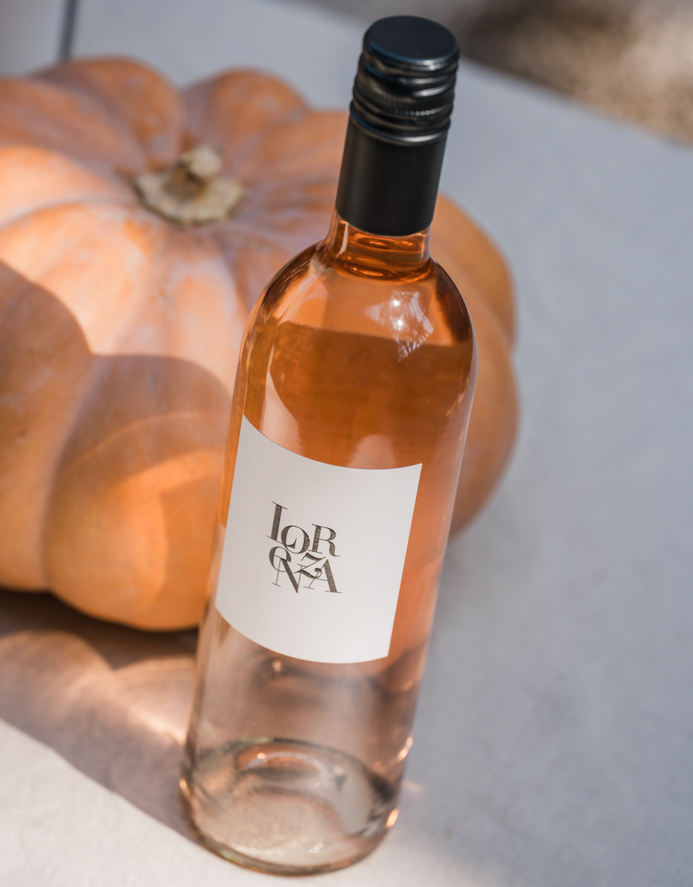 Bottle of Lorenza Rosé with a pumpkin