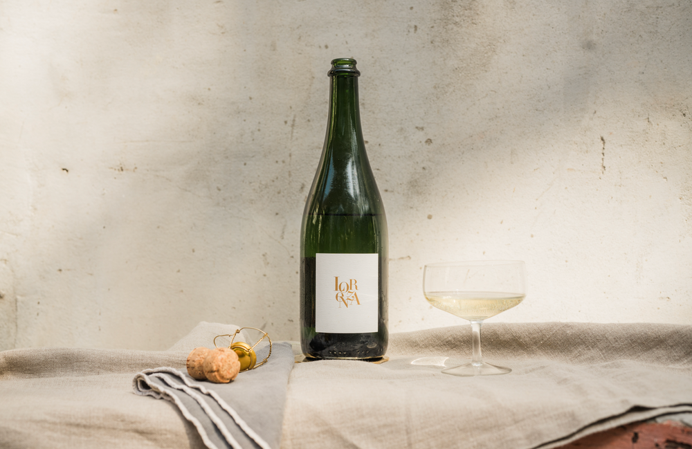 Single Bottle of Lorenza Sparkling Picpoul Blanc with glass and cork