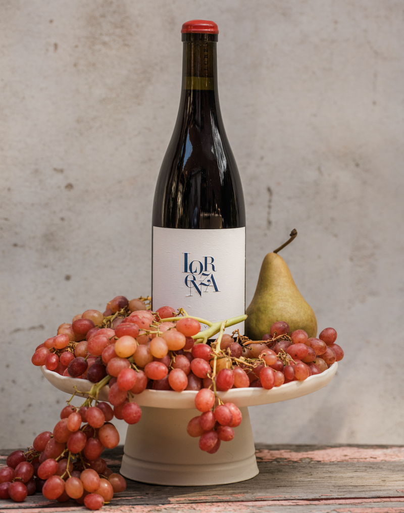 one bottle of Lorenza old vine carignan with grapes and a pear